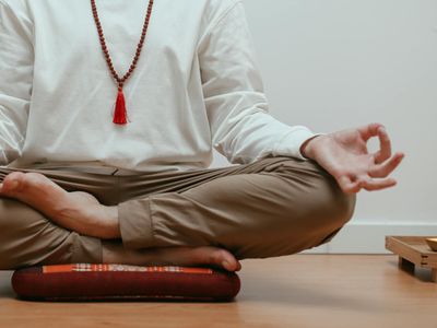 Close-up of hands in a meditative mudra position.